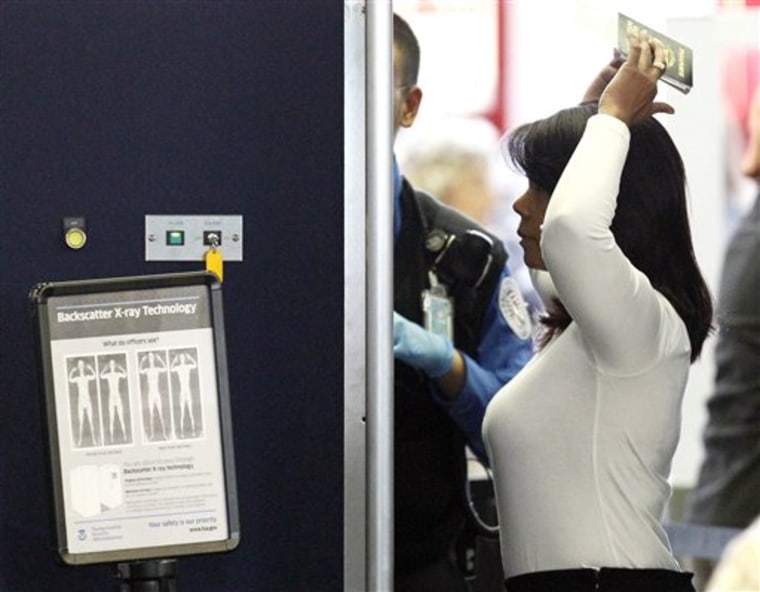 An airline passenger undergoes a full-body scan Wednesday at O'Hare International Airport in Chicago. 